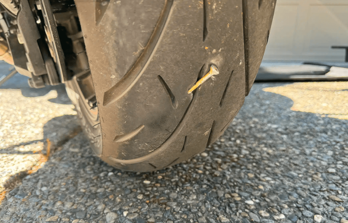 Tire with a nail stuck in it - why you need good tires