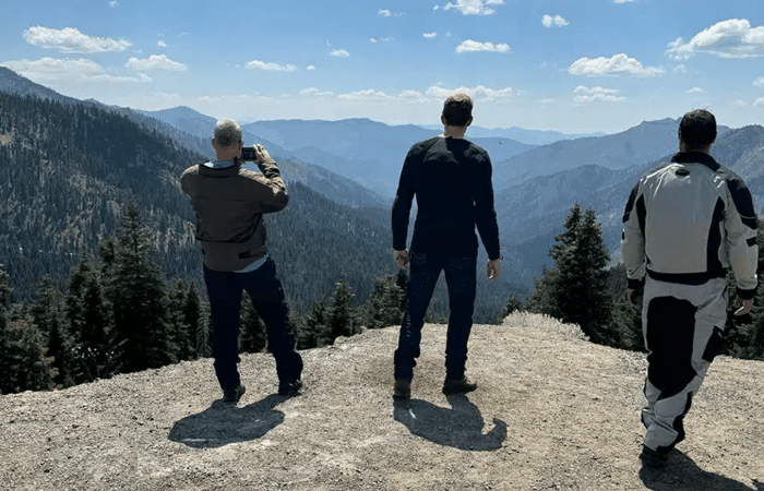 How to stay cool on a hot day: a group of bikers looking at the mountains around them